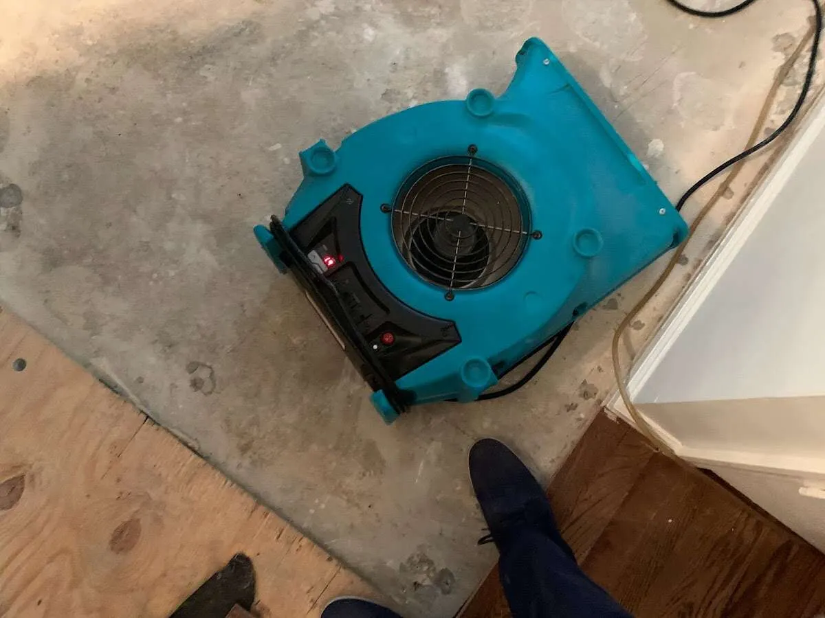 Air mover drying subfloor during Commercial Water Damage Restoration in West Chester